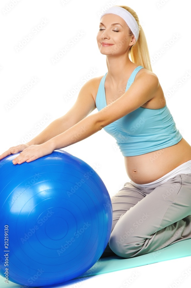 Young pregnant woman making exercise with a fitness ball Young pregnant woman making exercise with a fitness ball