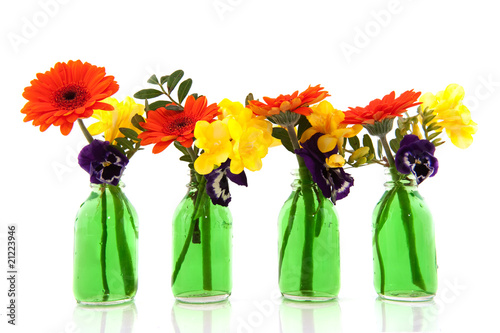 Flower bouquets in green bottles