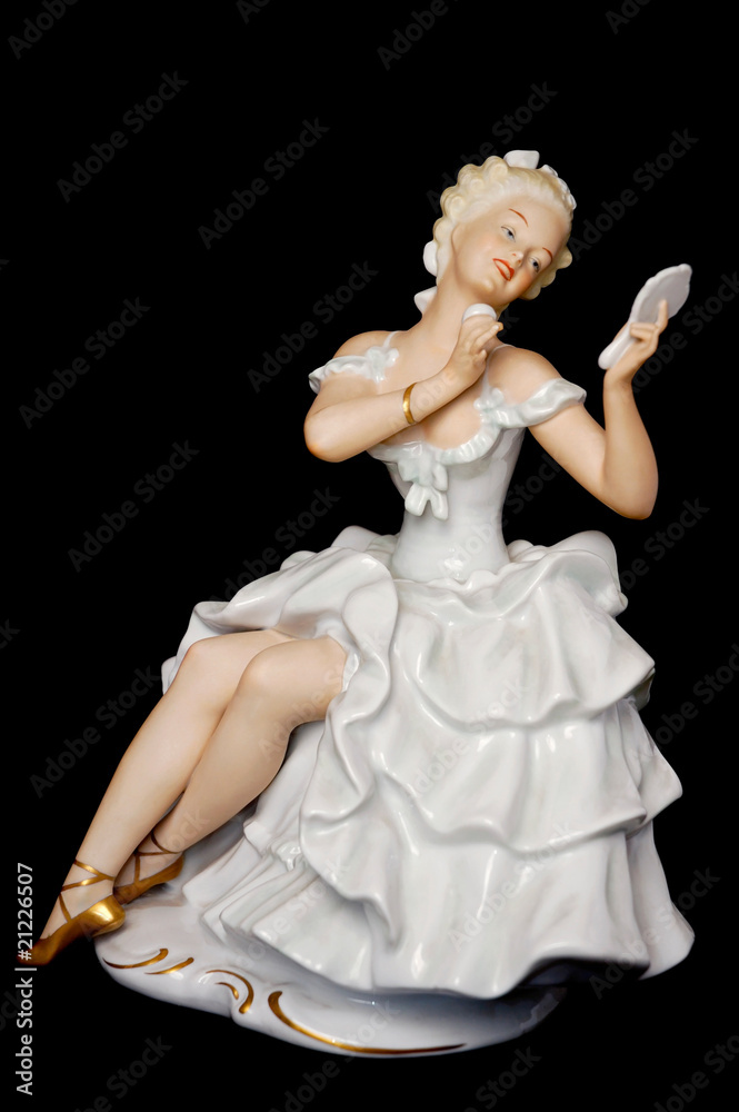 Fototapeta premium Ceramic Figure of a Pretty Young Lady Looking at a Mirror