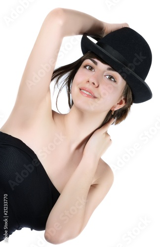 woman tries on a black hat