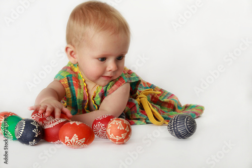 Baby girl playing with Easter eggs