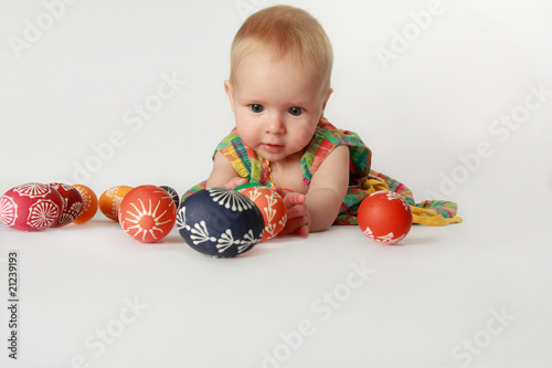 Baby girl playing with Easter eggs