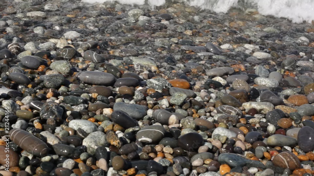sea surf with spume covering pebble coast, macro shooting sea surf with spume covering pebble coast, macro shooting