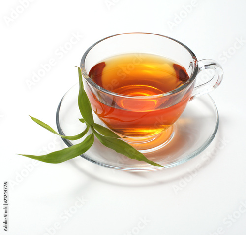 cup with tea with green leaf