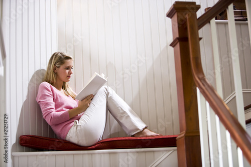 Teenage girl quietly relaxing and reading book