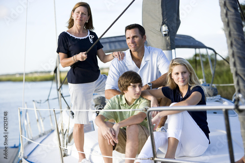 Family with teenagers relaxing together on boat