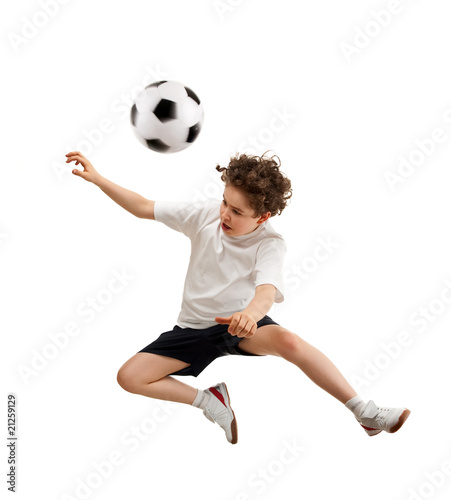Boy playing football isolated on white background © Jacek Chabraszewski
