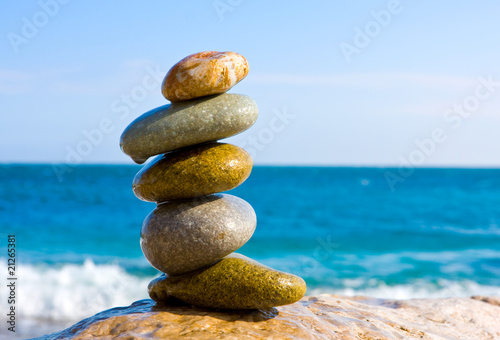 balanced wet stones on sea