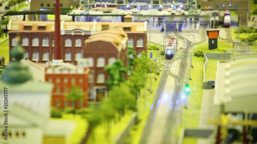 in small model city trian goes near to factory and church in small model city trian goes near to factory and church