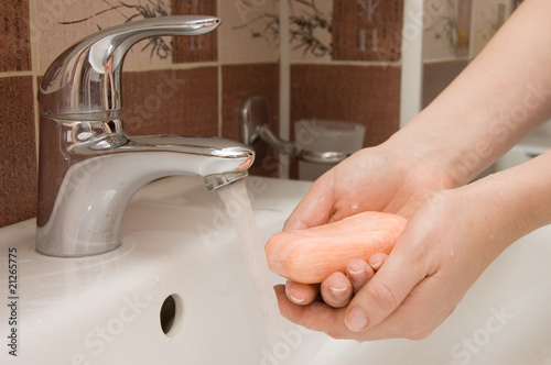 woman washing hand under running