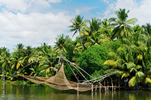 Coco trees reflection and chinese fishing nets, Kerala, India photo