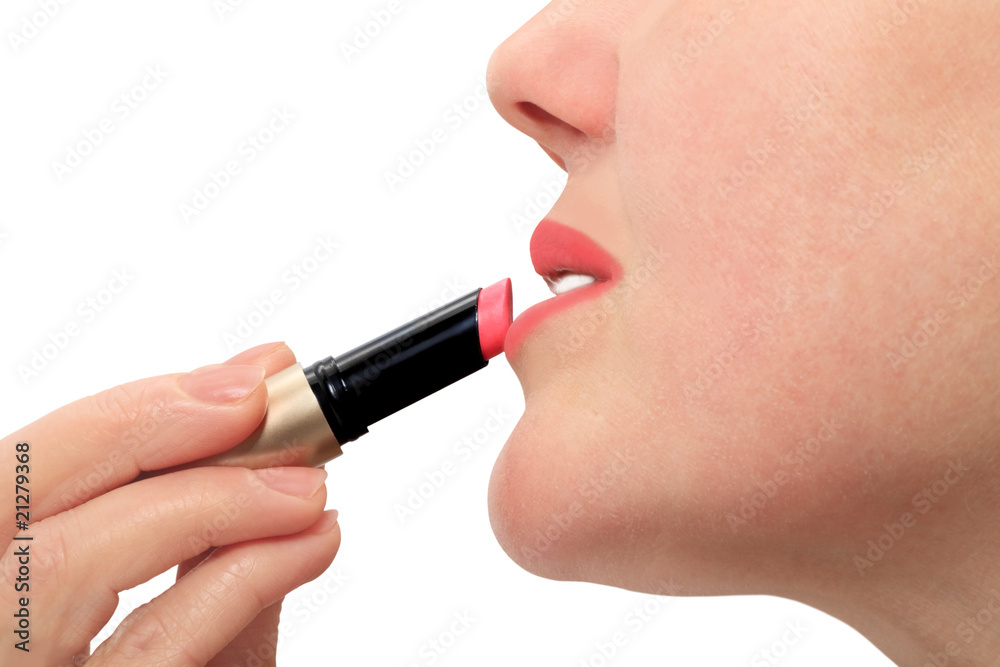 woman paints her lips with lipstick