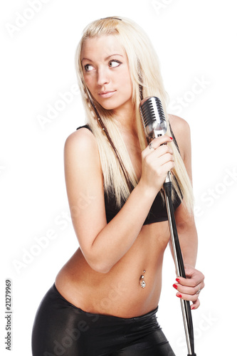 Sexy female singer holding retro microphone isolated on white