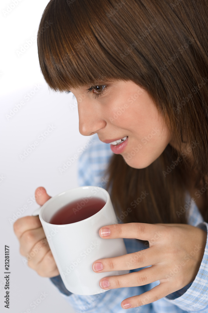 Female teenager with cup of tea for breakfast Female teenager with cup of tea for breakfast