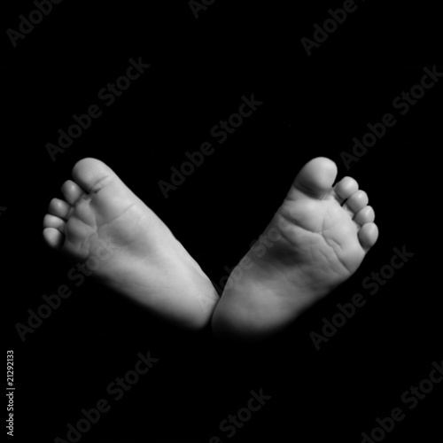Baby feet on black background