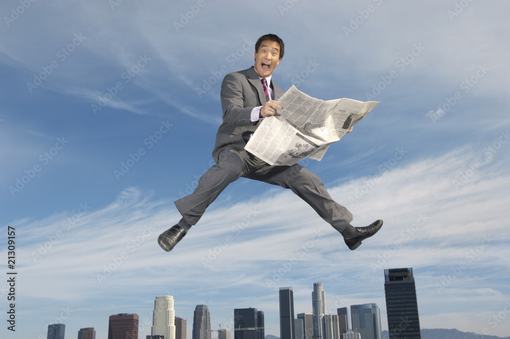 business man reading newspaper mid-air above city business man reading newspaper mid-air above city