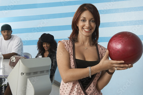 Fototapeta Naklejka Na Ścianę i Meble -  young woman at bowling alley holding ball portrait