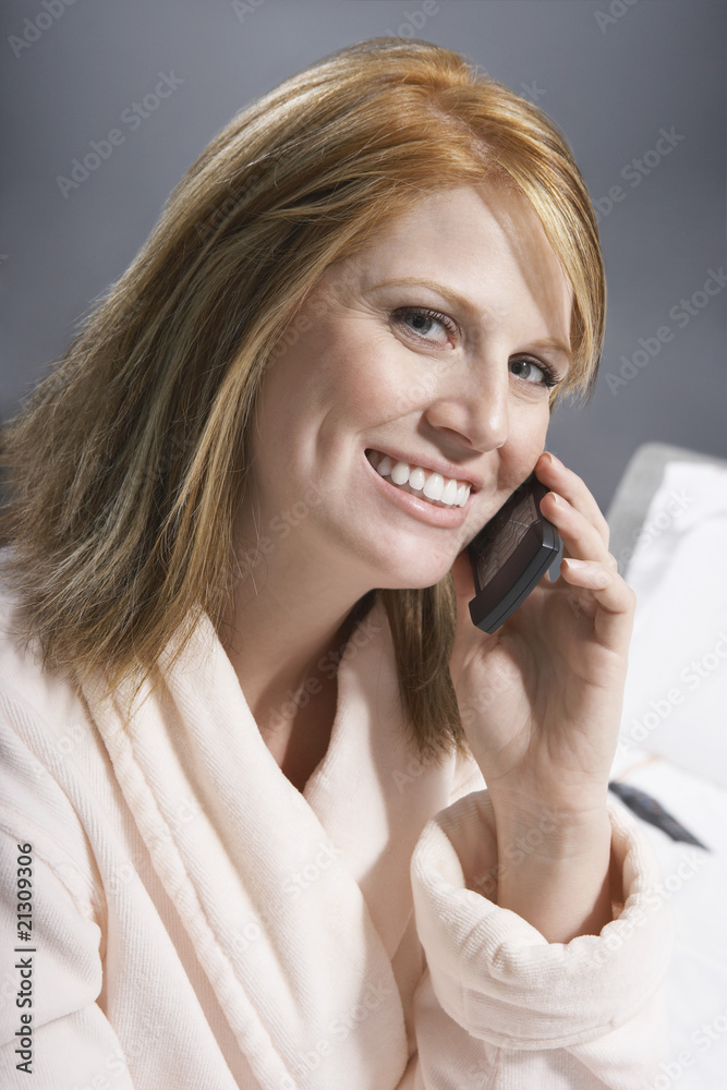 woman in bath robe using mobile phone (portrait) woman in bath robe using mobile phone (portrait)