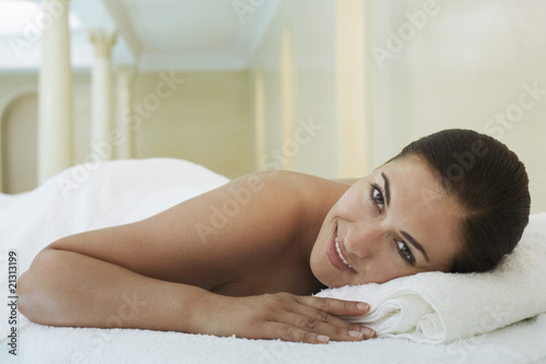 young woman lying on massage table portrait