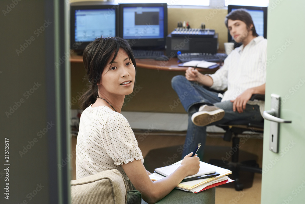 Fototapeta premium two office workers having meeting woman taking notes.