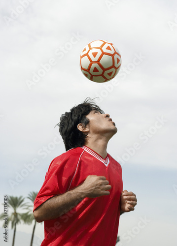 soccer player heading ball portrait