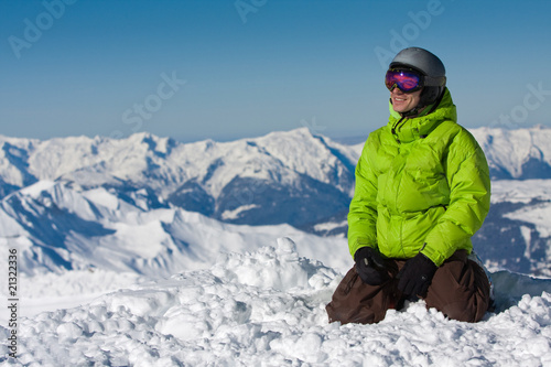 Young man on snow in mountains