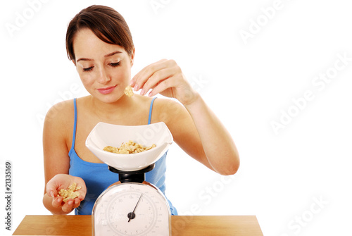 Woman weighing cereal on scales