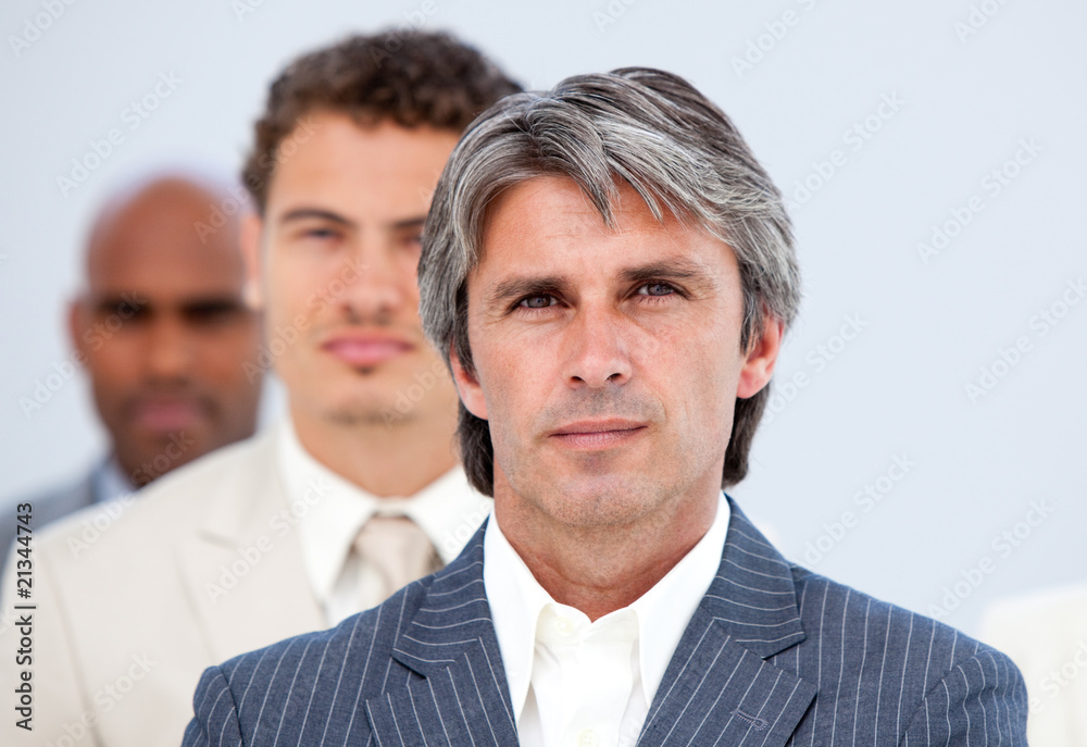 Self-assured manager and his team looking at the camera Self-assured manager and his team looking at the camera