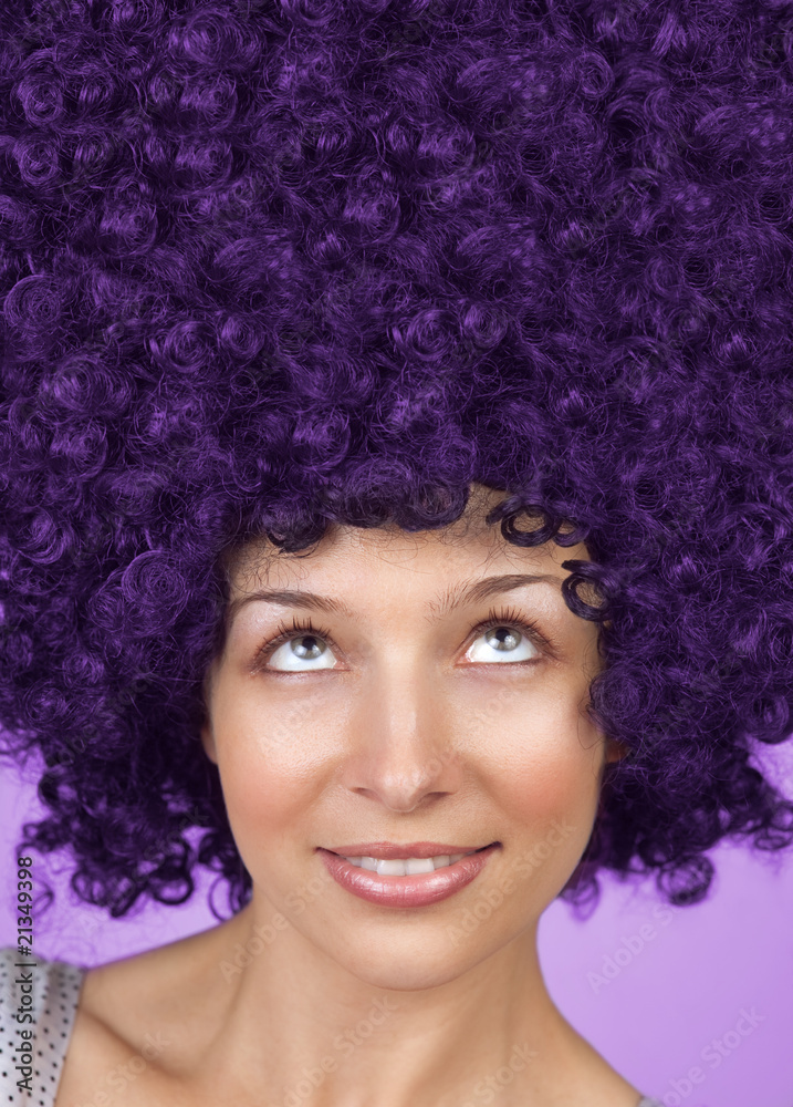 Woman with curly hair or wig looking up Woman with curly hair or wig looking up