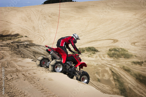 Teenager Riding ATV in Sand Dunes photo