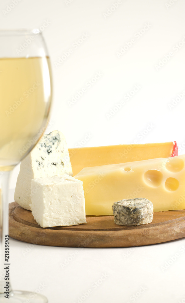 Glass of white wine and cheese on a cheese board Glass of white wine and cheese on a cheese board