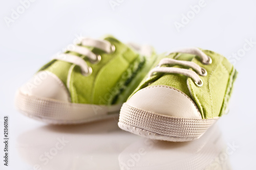 Green baby shoes on a white background