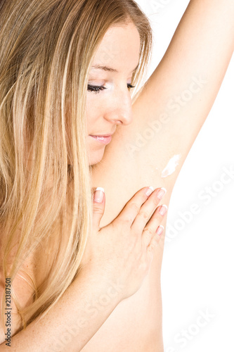 Causasian woman creaming armpit