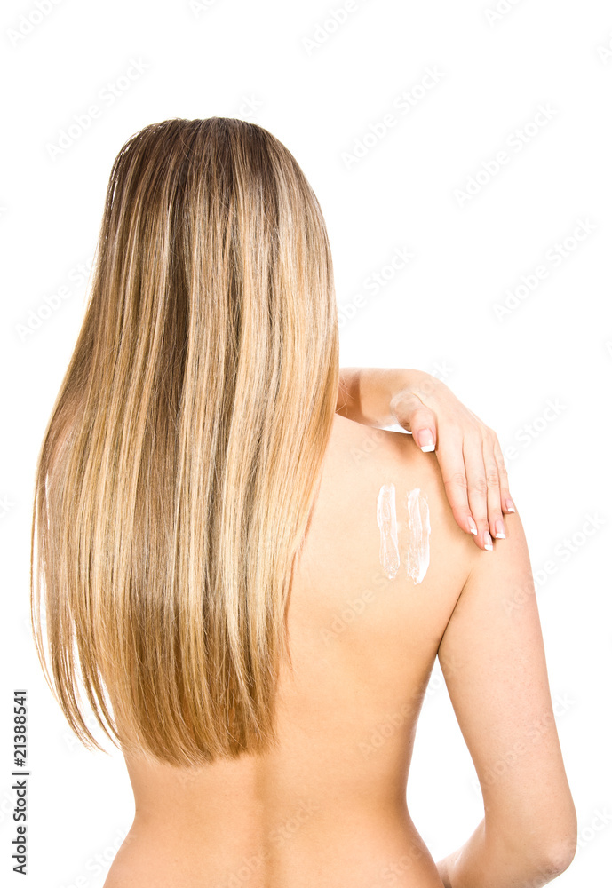 Causasian blonde woman creaming her back - obrazy, fototapety, plakaty 