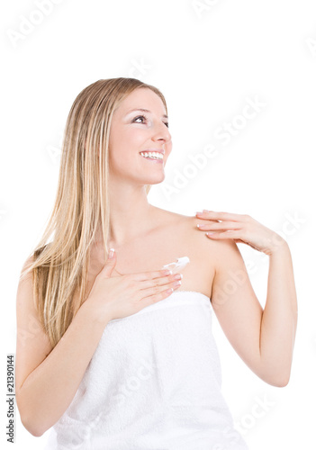 Smiling caucasian blonde creaming chest, french nails