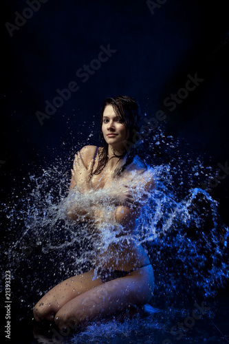 Beautiful girl in the water and spray