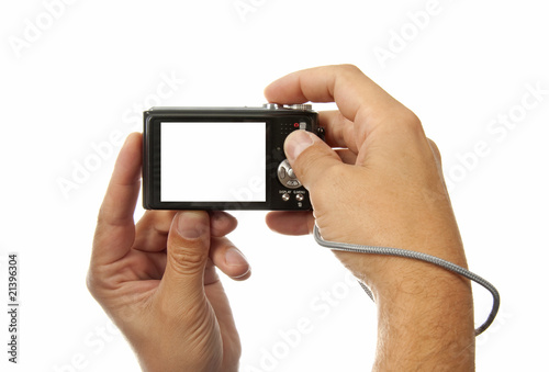 Hands with digital photo camera over white background