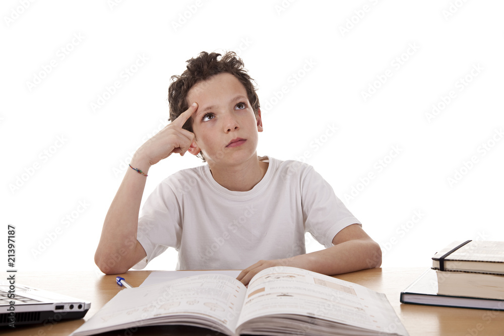 cute boy on the desk studying and thinking cute boy on the desk studying and thinking