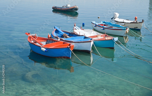 Rowboats in clear sea.