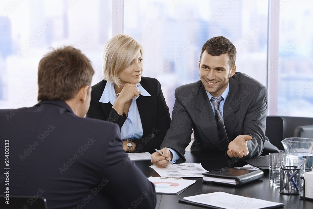 Businessman smiling at meeting Businessman smiling at meeting
