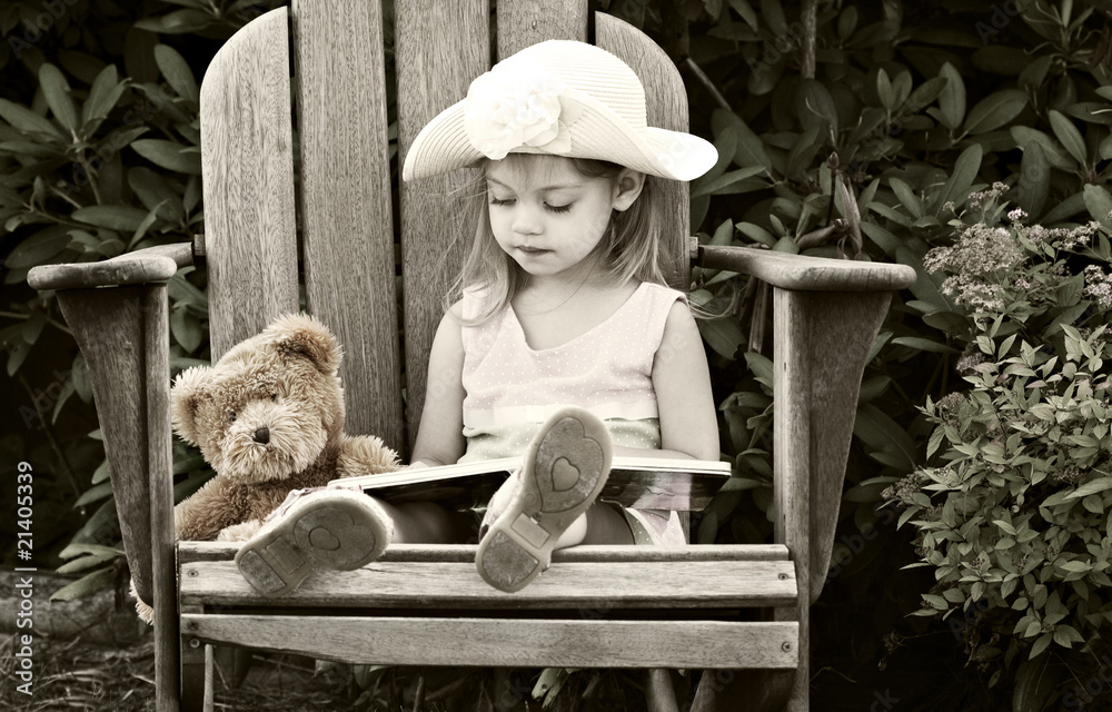 Vintage style image of a child reading to her teddy bear.