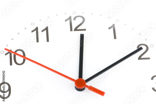 White clock showing time about twelve isolated
