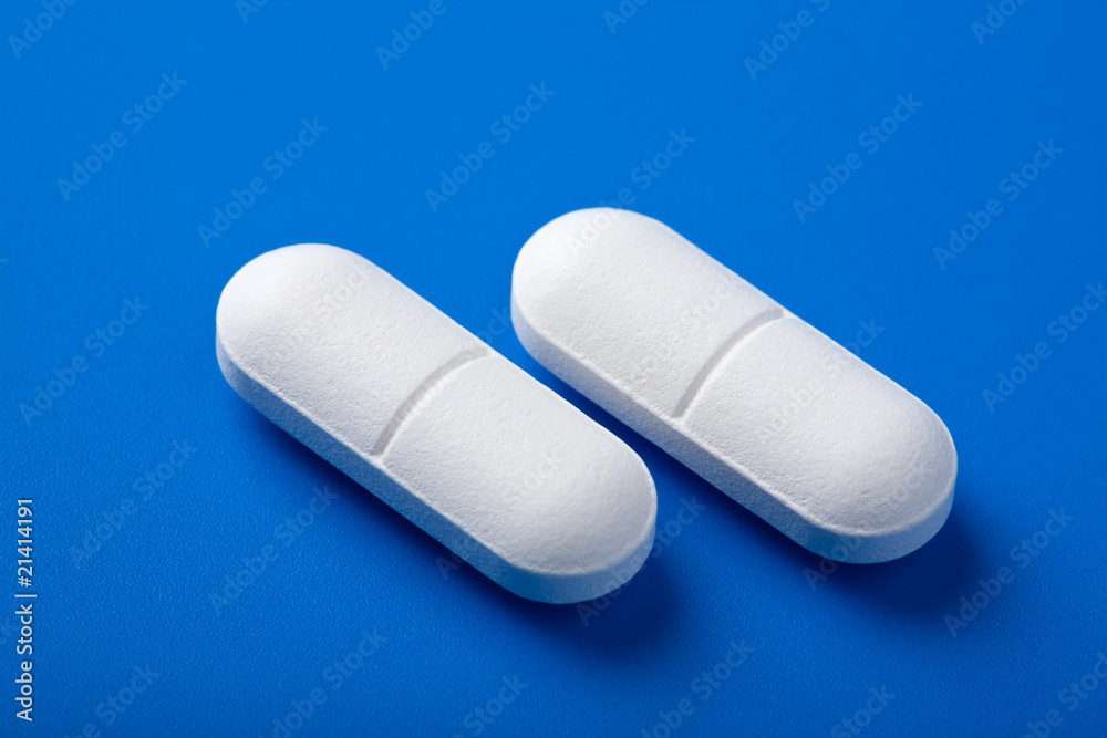 white pills over blue