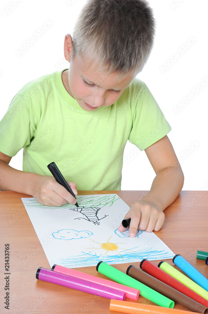 Caucasian boy drawing on paper with crayons Caucasian boy drawing on paper with crayons