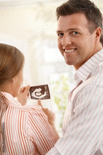 Couple with ultasound baby picture.