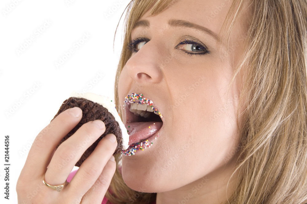 woman licking cupcake looking