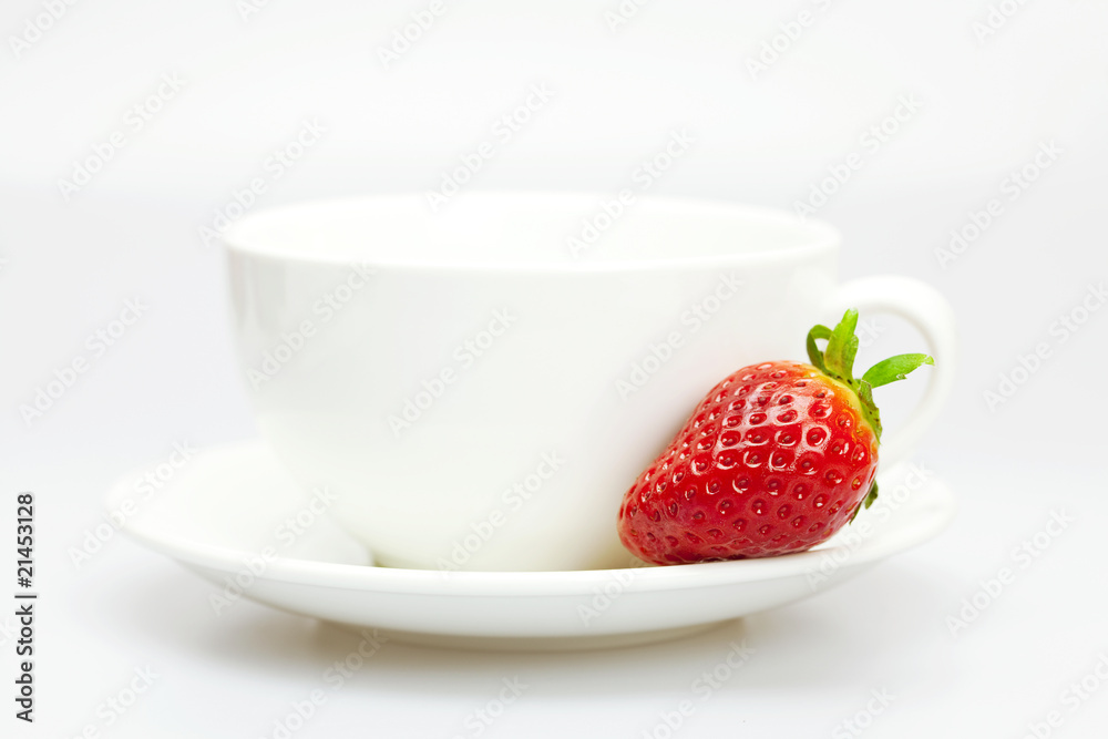 white cup and strawberries isolated on white white cup and strawberries isolated on white