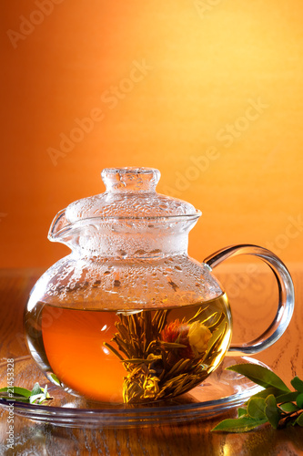 Glass of greean tea and teapot