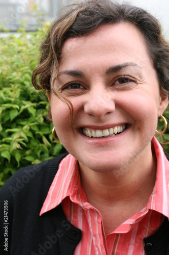 Woman, forty years old, brown curled hair, laughing