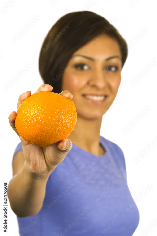 Smiling oung ethnic woman holds an orange. Smiling oung ethnic woman holds an orange.